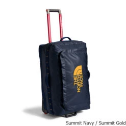 The North Face Base Camp Voyager 29" Roller 94 Liter Wheeled Carry-On Bag -CampMate Shop Base Camp Voyager 29in Roller 94L Wheeled Carry On Bag Summit Navy Gold